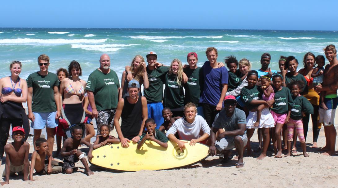 Group of volunteers and children at a surfing project in South Africa Volunteers and children at surfing project in South Africa